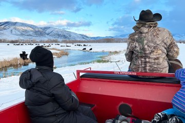 a group of people sitting in a boat on a body of water