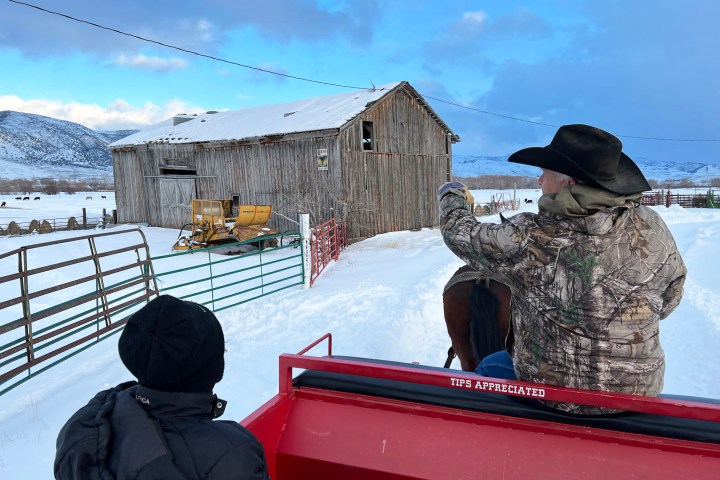 a group of people sitting at a dock in the snow