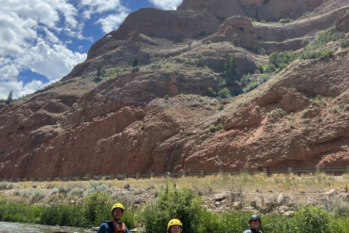 a raft next to a body of water with a mountain in the background