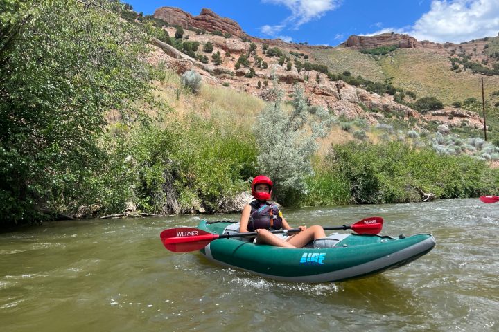 a person riding on the back of a boat in the water