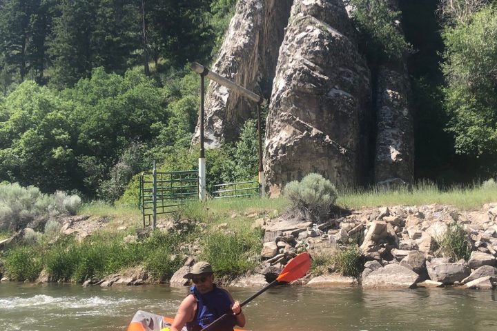 a person riding on the back of a boat in the water