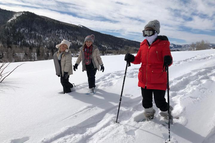 a group of people riding skis on top of a snow covered slope