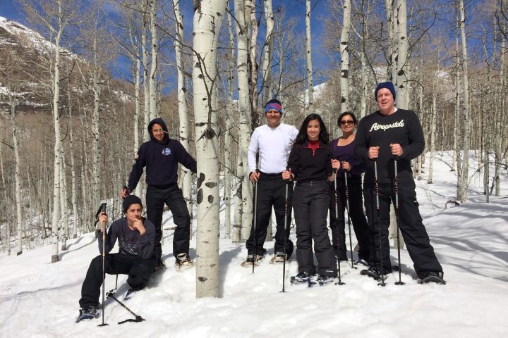 a group of people standing on top of a snow covered slope