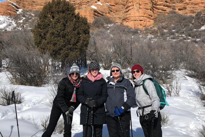 a group of people standing on top of a snow covered slope