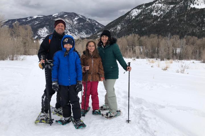a group of people standing on top of a snow covered slope