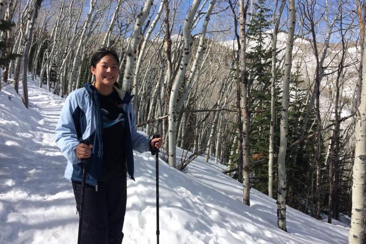 a person standing on top of a snow covered forest