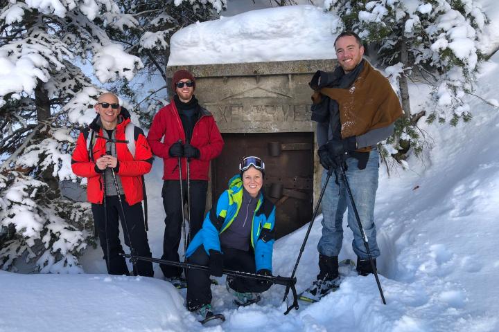 a group of people posing for a picture in the snow