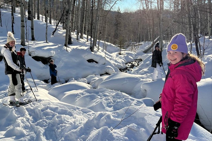 Kids snowshoeing in the snowy mountains