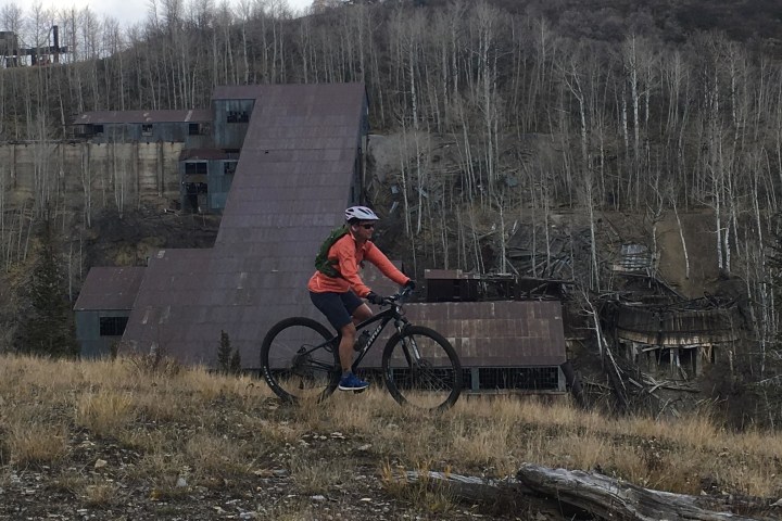 a man riding a bike down a dirt road