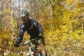 a person riding a bicycle in a forest