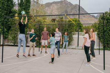 a group of people standing on a basketball court