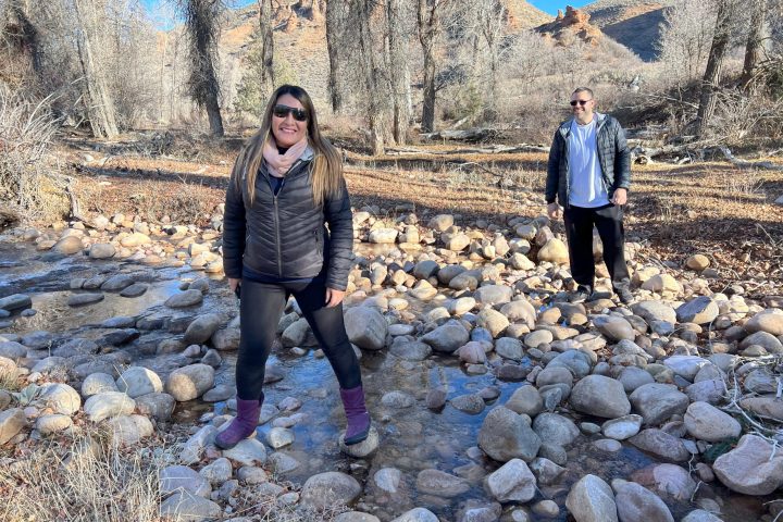 people hiking along a creek