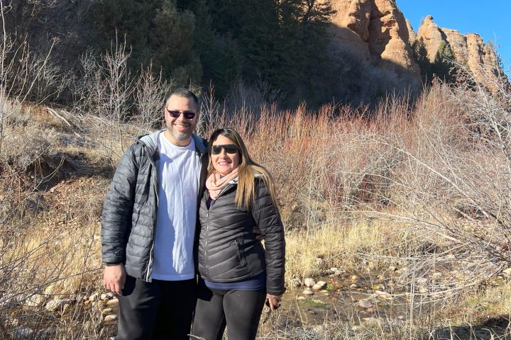 a person standing next to a tree