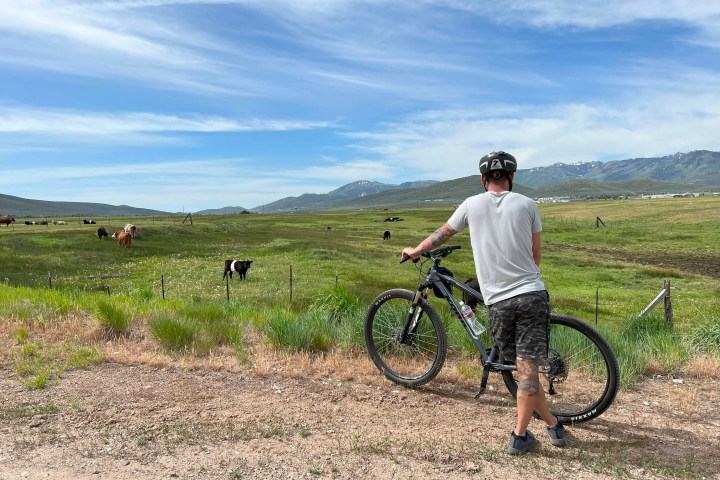 a man standing next to a bicycle