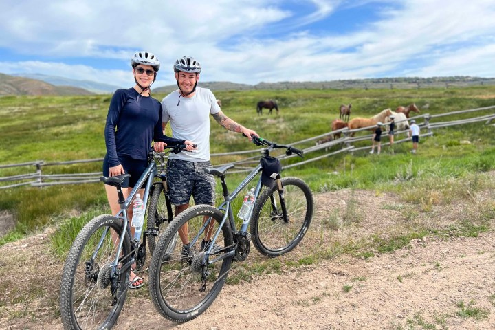 a man standing next to a bicycle