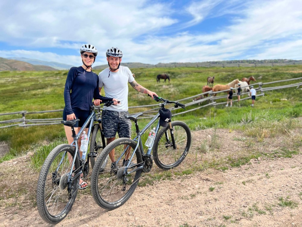 a man standing next to a bicycle
